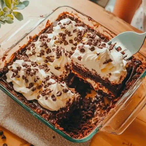 Chocolate Lasagna Recipe: Dreamy No-Bake Layered Dessert 3 chocolate lasagna recipe photo 5 dessert in a rectangular dish showing four distinct layers - cookie crust, cream cheese, chocolate pudding, and whipped topping - with a slice being served