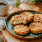 Churro cheesecake donut cookies with cinnamon sugar coating and creamy filling on rustic plate